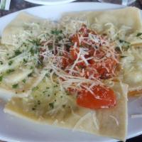Ravioli · Homemade pasta filled with chard, ricotta, Romano and Parmesan cheeses topped with marinated...