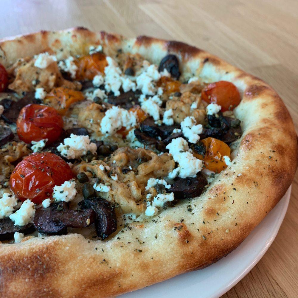 Baba Ganesh Pizza · Charred eggplant, roasted tomato, cremini mushrooms, garlic confit, feta, capers and za'atar spice. Substitute gluten free crust for an additional charge.