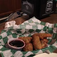 Poppers · Breaded jalapenos, cheese, fried golden crisp and raspberry dipping sauce.