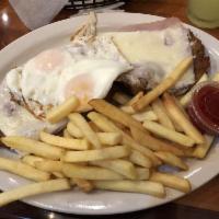 Milanesa Completa · Breaded steak or chicken with ham, cheese, eggs sunny side up and fries.