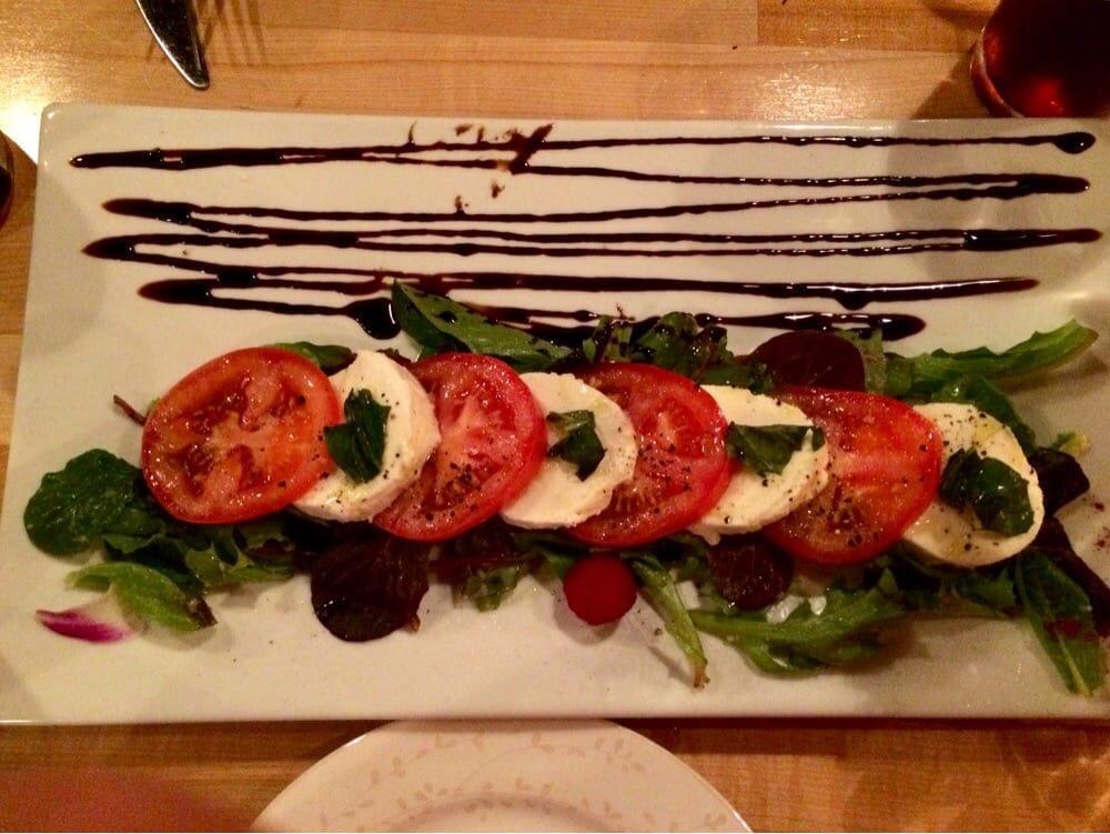 Caprese Salad · Homemade mozzarella, sliced tomatoes, basil and extra virgin olive oil. Vegetarian.