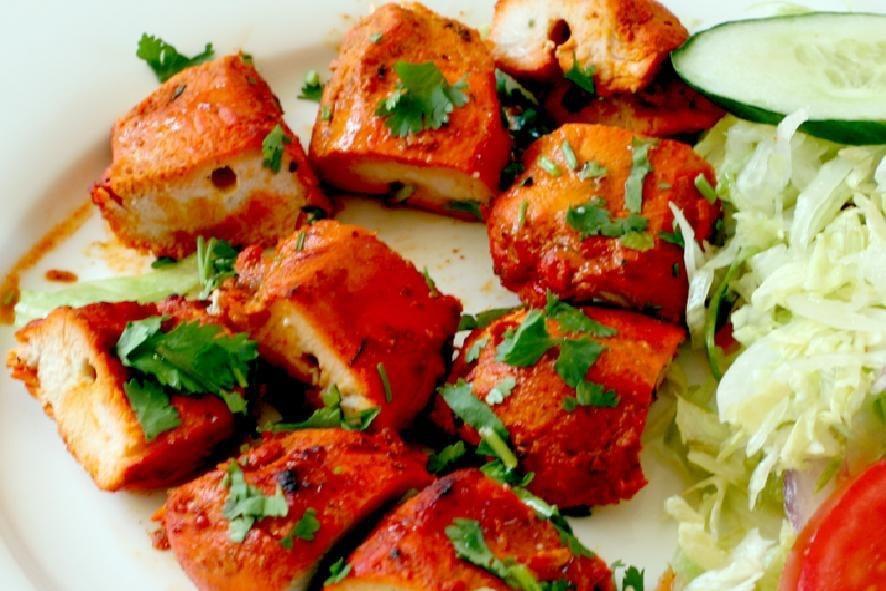 Chicken Tikka · Tender boneless chicken pieces marinated and roasted in clay pit. Served with rice.