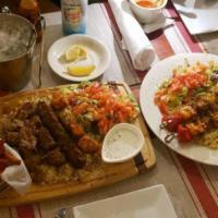 Chicken Adana · Grounded chicken mixed with red bell peppers, parsley and seasonings. Cooked on skewers. Ser...