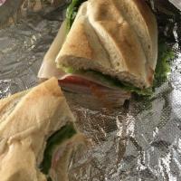 Smoked Turkey Sandwich · Served with green leaf lettuce, tomatoes, onions and pickles with choice of mayonnaise, dijo...