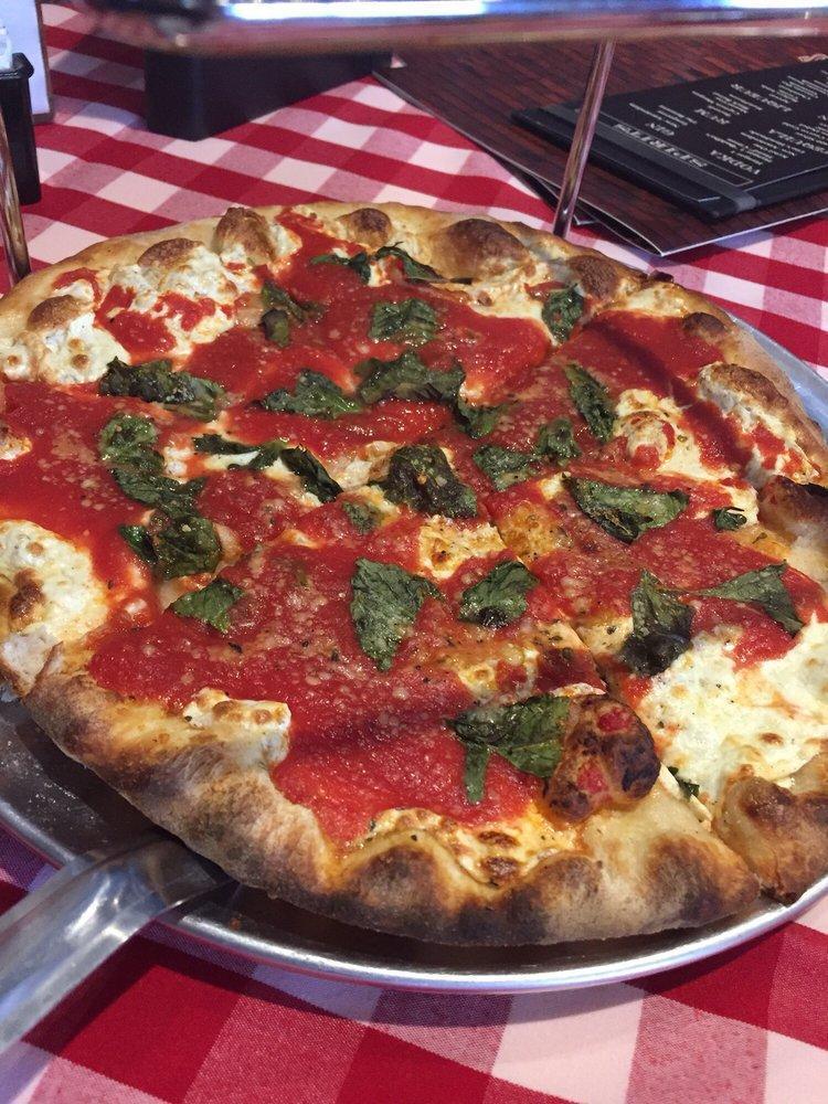 Margherita Pizza · Traditional pizza with extra famous sauce and fresh basil.