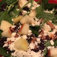 Enlightened Spinach Salad · Fresh spinach topped with dried cherries, apples, house made candied pecans and feta cheese....