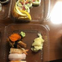 Monster Roll · Tuna, salmon, white fish, avocado and scallions served with half ponzu sauce and half rice v...
