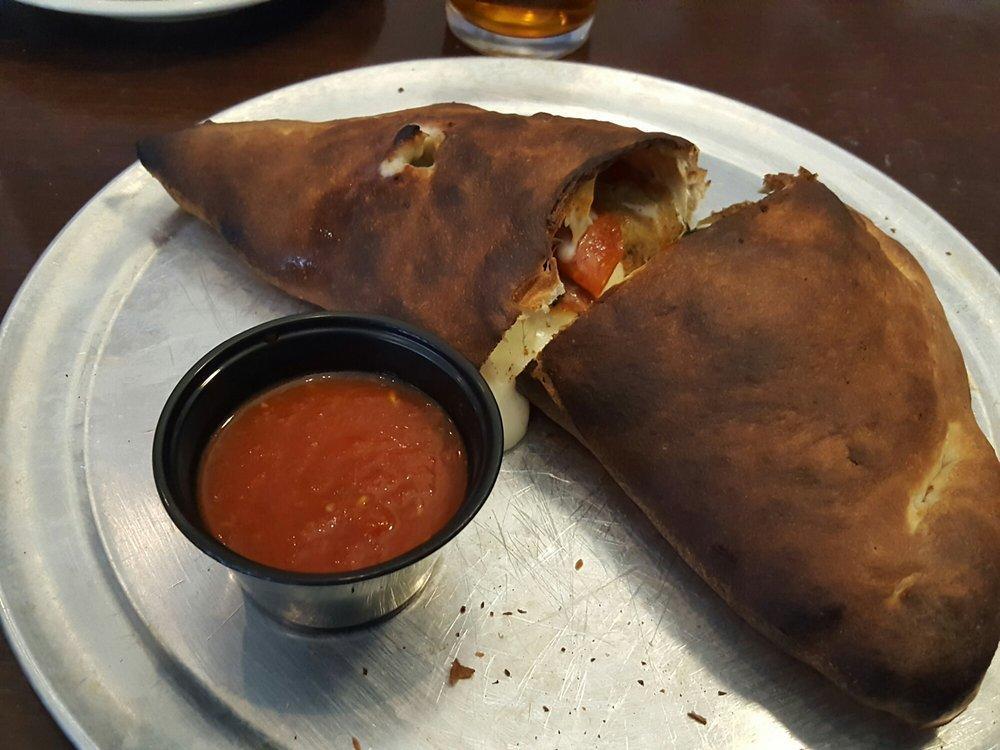 Spinach Pie Calzone · Calzone filled with mozzarella, spinach, pepperoni and roasted garlic. Served with a side of marinara.