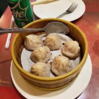 Xiao Long Bao · 6 pieces. Delicious thin-skinned dumplings, stuffed with ground pork and chicken broth and p...
