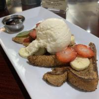 French Toast · Brioche bread battered with almond milk, vanilla and blue agave, topped with fresh seasonal ...