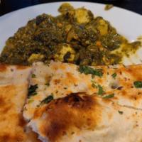 Palak Paneer · Spinach cooked with mild creamy sauce and topped with sauteed cheese cubes.