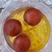 Gulab Jamun · Deep fried dough balls served hot in rose scented sugar syrup.