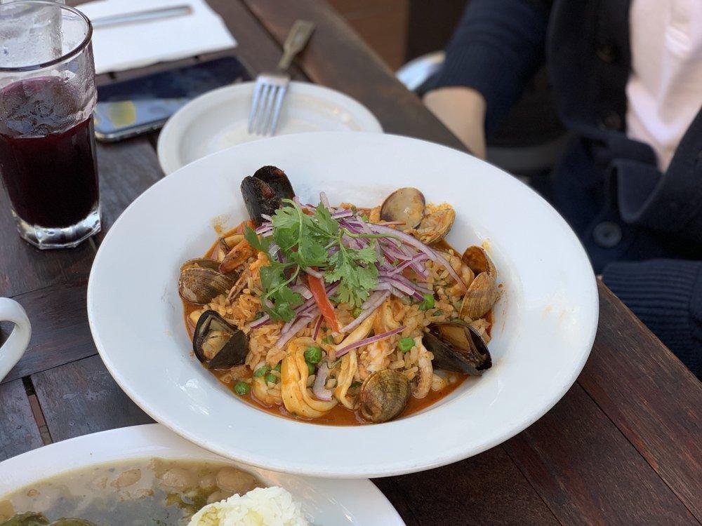 Seafood Paella · Arroz con mariscos. Gluten-free. Peruvian style paella a fresh seafood and rice mixture of calamari, prawns, mussels, clams, ají panca, and Parmesan cheese. Topped with salsa criolla.