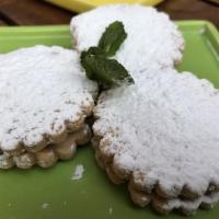 Alfajores · Delicate shortbread cookies filled with manjar blanco a sweet, caramel-like filling and cove...