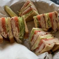 Turkey Club Sandwich · Triple-decker sandwich with turkey, bacon, lettuce, tomato, and mayonnaise on your choice of...
