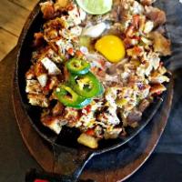 Sizzling Pork Sisig · Grilled pork mask & deep-fried pork belly sauteedin onion, bell pepper & jalapeno