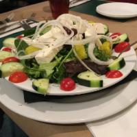 Greek Salad · Fresh leaf lettuce with feta, Kalamata olives, pepperoncini, cucumbers, tomato and onion. Gl...