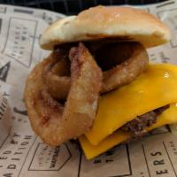 Rodeo Burger · A 2 patty Texan delight. Topped with cheddar cheese, our signature crispy onion rings and a ...