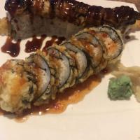 Dragon Roll · Tempura shrimp, avocado, cucumber, unagi with eel sauce and sesame seed.
