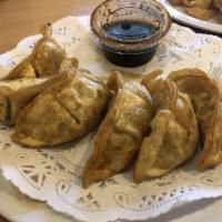 Pot Stickers · Pan fried dumplings filled with pork and cabbage.