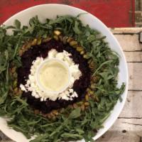 Arugula Beet Salad · organic arugula, beets, pistachios, goat cheese with creamy dill dressing. Gluten free