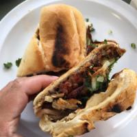 Torta · Choice of meat and jalapenos. Includes oaxaca cheese, black beans and chipotle mayo.
