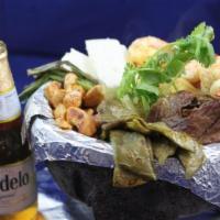 Molcajete · Serves 2 . A great combination of ranchera meat, grilled chicken and shrimp simmered in toma...