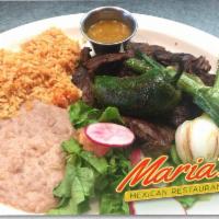 Carne Asada Plate · Marinated skirt steak charbroiled to perfection served with rice, refried beans, fresh guaca...