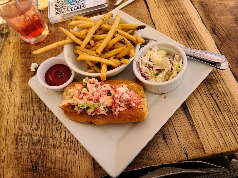 Lobster Roll · Brioche roll, fresh lobster chunks, diced celery, light orange mayo, creamy coleslaw. Add fries or house salad for an extra charge.
