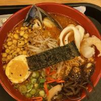 Spicy Seafood Ramen Noodles · Spicy creamy pork broth, squid, shrimp, and mussels, wheat noodles, sweet corn, black mushro...