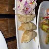Potstickers · Seared chicken & vegetable dumplings, Asian slaw, traditional soy dipping sauce.