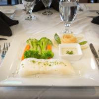 Chilean Sea Bass · Poached in a white wine broth and spices. Covered with Dijon mustard, capers, and a cream sa...