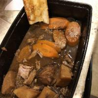 Pot Roast · Slow cooked pot roast in natural juices. Served with potatoes, carrots and onions.