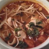 Tom Yum Noodle Soup · Rice noodles in Thai style hot and sour coconut soup with chicken, shrimp, lemongrass, tomat...