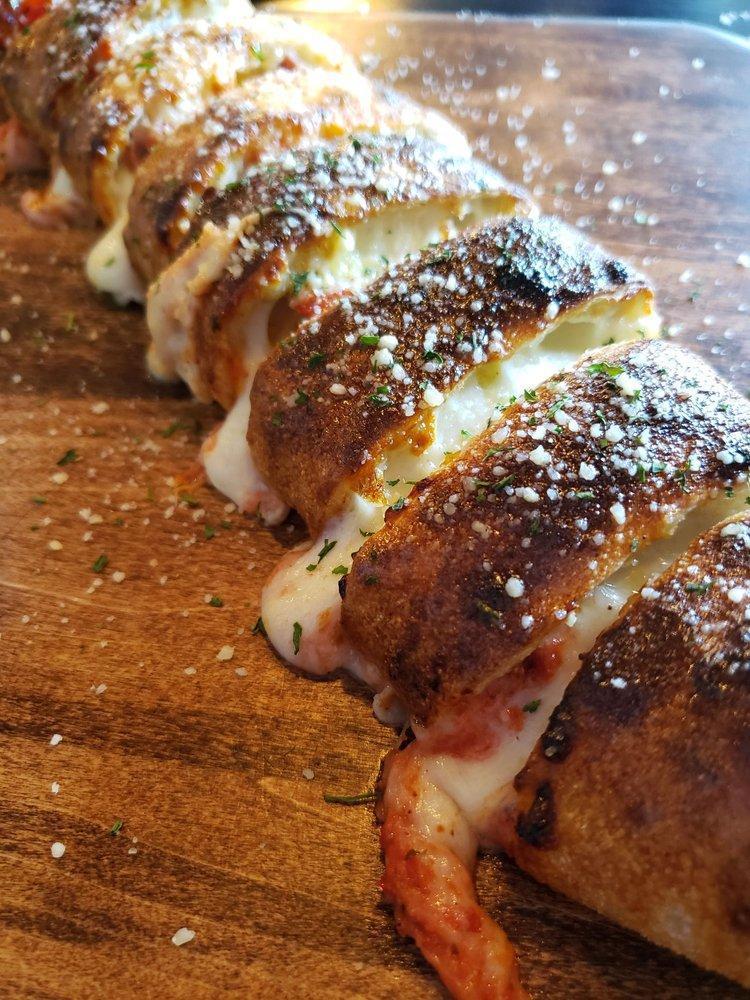 Pepperoni Roll · Handcrafted using our fresh baked dough, stuffed with pepperoni, whole-milk mozzarella, house pizza sauce, topped with garlic butter, served with house marinara.