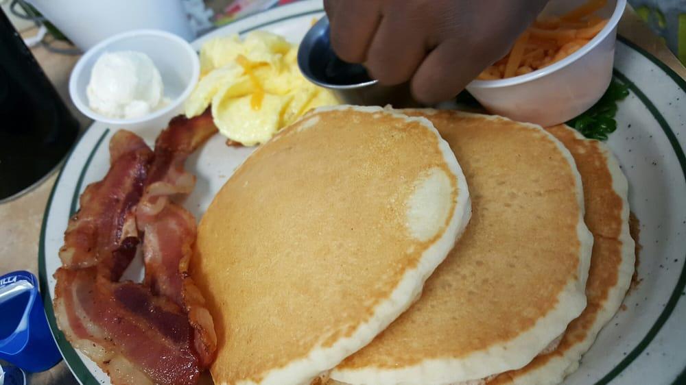 Swedish Pancake Breakfast · Crepe style pancakes rolled then topped with glazed strawberries or marion berry topping and whipped cream. Served with 2 eggs, 2 bacon strips, 2 sausage links, and hash-browns or country potatoes.