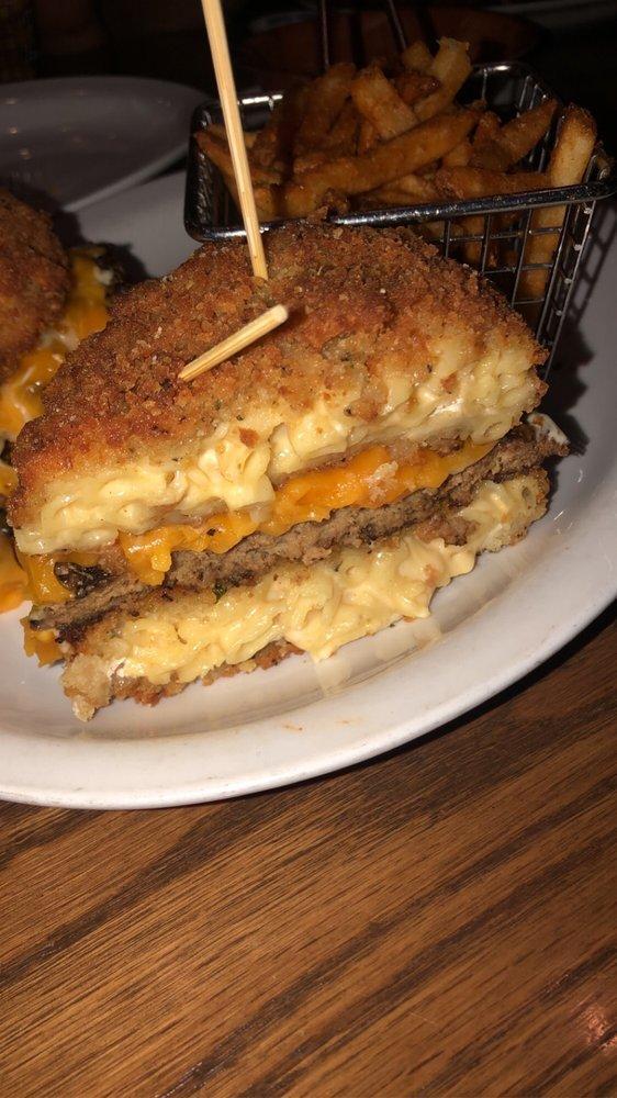 Mac and Cheese Burger · Our homemade gooey mac and cheese is the bun for this 8 oz. brisket/chuck burger. Topped with American cheese, lettuce and caramelized onions. Served with choice of side.