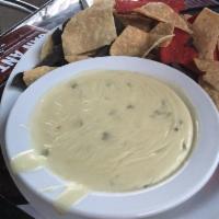 Texas Queso · Served with tri-color tortilla chips.