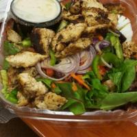 Blackened Chicken Salad · Garden salad topped with blackened chicken strips and a hard-boiled egg. Served with garlic ...