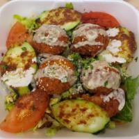 Falafel Salad · Falafels, lettuce, tomatoes, cucumbers, vinaigrette dressing and topped with tahini sauce. V...