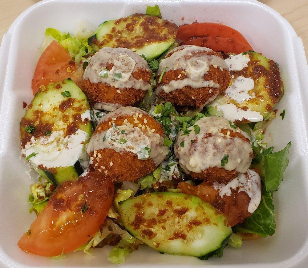 Falafel Salad · Falafels, lettuce, tomatoes, cucumbers, vinaigrette dressing and topped with tahini sauce. Vegetarian. Gluten free.
