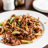 Mongolian Beef · Quickly stir-fried with onion and scallion on a bed of crispy rice sticks.