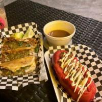 Sonoran Dog · Foot long bacon wrapped hot dog topped with pinto beans, sautéed onion, tomato, mayo, and mu...