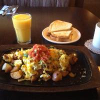 Santa Fe Skilllet · Bacon, avocado and cheese scrambled with eggs, diced green chiles and green onion over count...