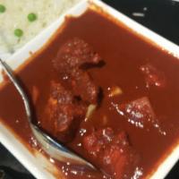 Chicken Vindaloo · Cubes of chicken cooked in a fiery sauce with fresh ginger, garlic and potatoes. Served with...