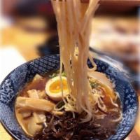 Spicy Black Tonkotsu · Rich tonkotsu broth and black garlic oil with an appetizing chili sauce, giving it a roasted...