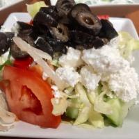 Greek Salad · Lettuce, tomatoes, cucumbers, olives and feta cheese, topped with a vinegar and olive oil dr...