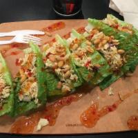Coconut Chicken Lettuce Wrap · Romaine hearts, coconut chicken, tomato, almonds, red onions, Swiss cheese, drizzled with ra...