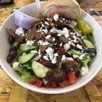 Greek Salad · Romaine topped with gyro meat, tomatoes, cucumbers, Greek peppers, flaky feta cheese, olives...