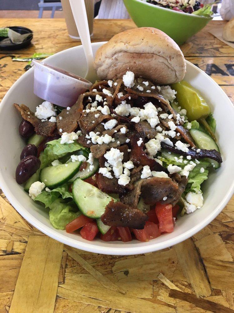 Greek Salad · Romaine topped with gyro meat, tomatoes, cucumbers, Greek peppers, flaky feta cheese, olives and seasonings. Served with Greek dressing.